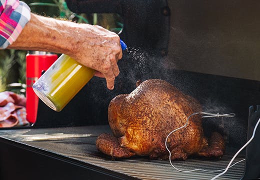 Spritzing turkey with pineapple juice